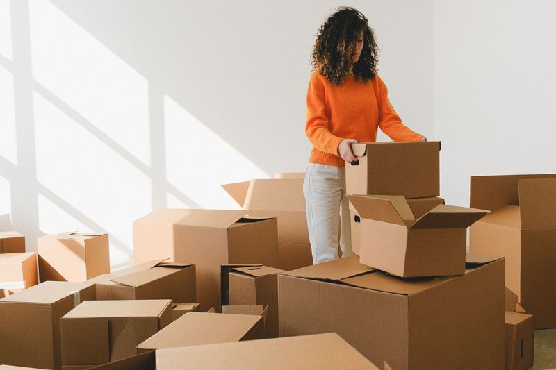 Moving crew arranging furniture in a newly relocated Stamford office