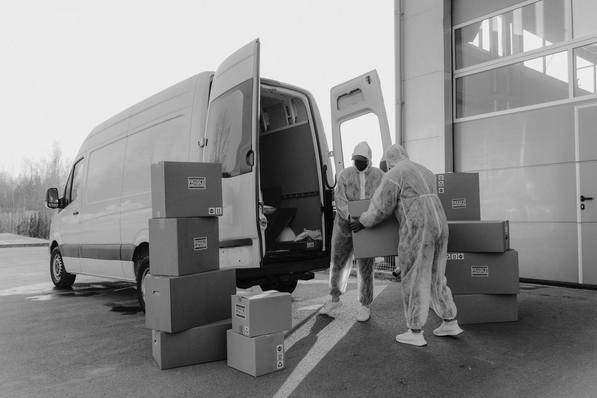 Moving professionals carefully loading boxes into a truck in Stamford